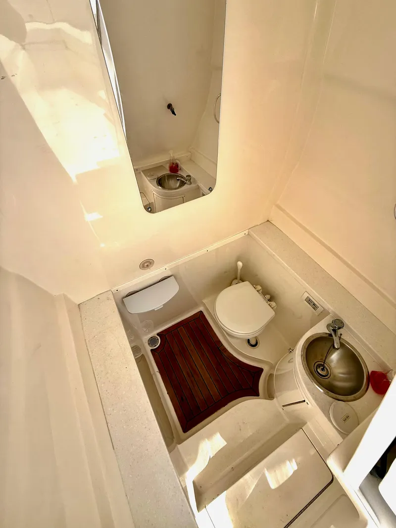 Slide: The Image of 2015 Intrepid 375 Center Console boat interior with toilet and sink. - 27