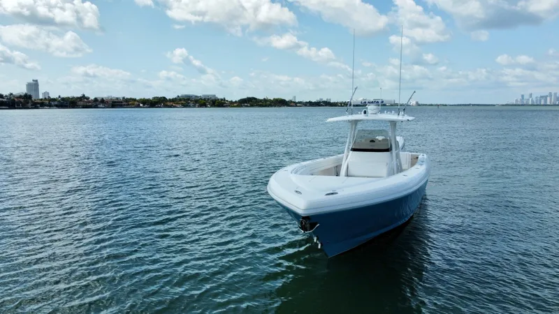 Slide: The Image of 2015 Intrepid 375 Center Console boat on calm water under a partly cloudy sky. - 5