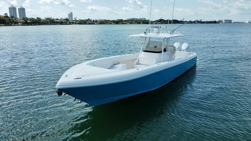 Slide: The Image of 2015 Intrepid 375 Center Console boat on calm water, clear sky background. - 6