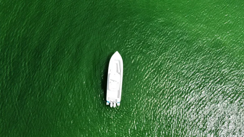 Slide: The Image of Aerial view of 2015 Intrepid 375 Center Console boat on green water. - 8
