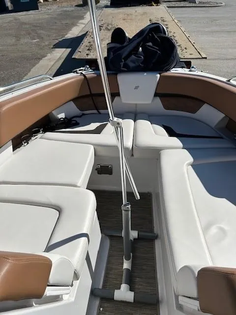 Slide: The Image of 2018 Four Winns Horizon H290 boat interior with white and brown seating. - 5