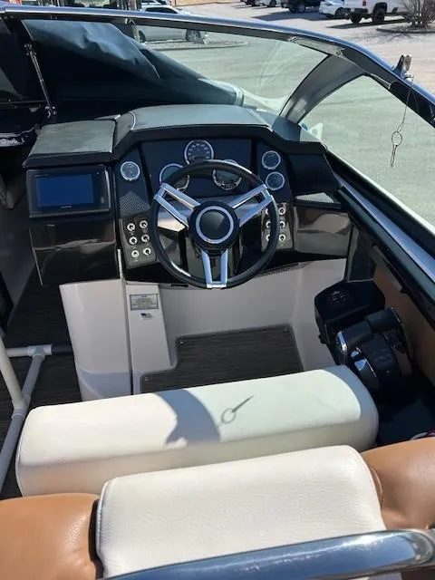Slide: The Image of 2018 Four Winns Horizon H290 boat dashboard with steering wheel and control panel. - 6
