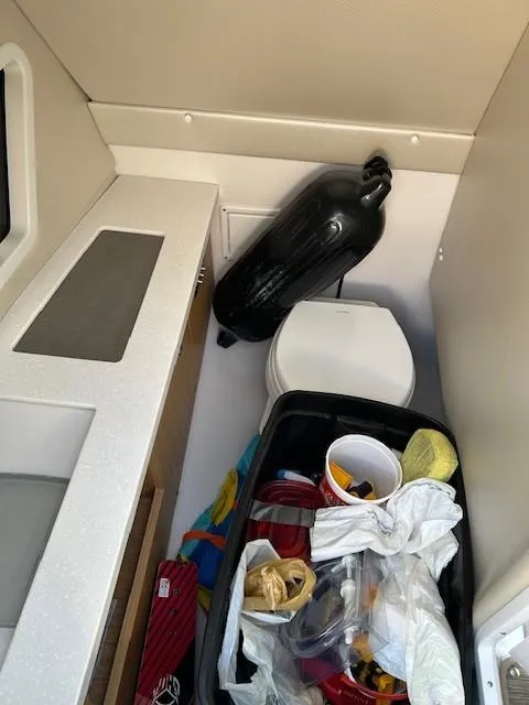 Slide: The Image of 2018 Four Winns Horizon H290 boat interior with storage and toilet area. - 7