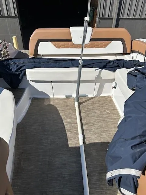 Slide: The Image of 2018 Four Winns Horizon H290 boat interior with seating and cover. - 9