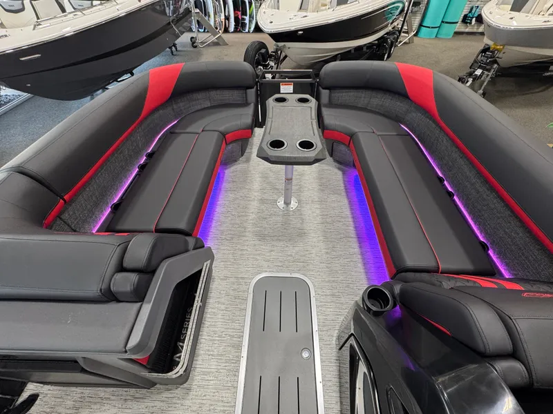 Slide: The Image of Luxurious 2025 Bennington M Quad Bench 24 MFB boat interior with LED lighting and sleek seating. - 13