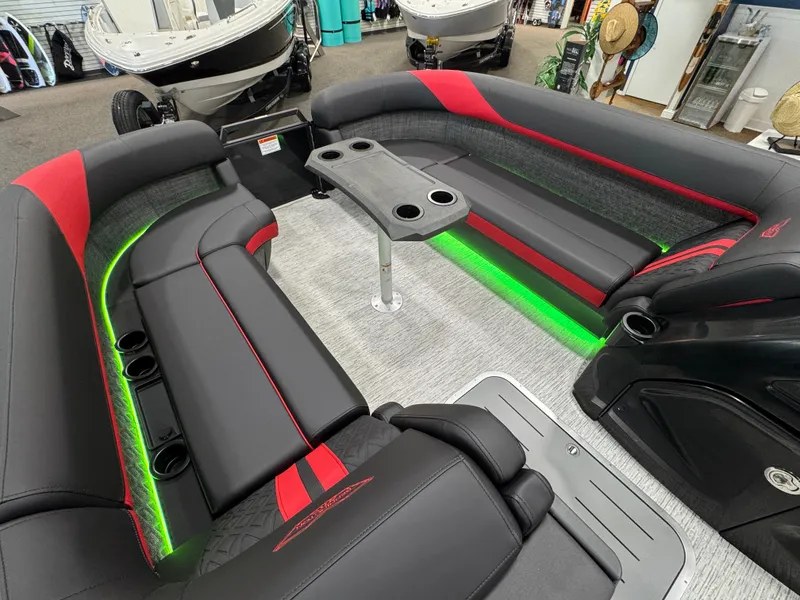 Slide: The Image of Luxurious 2025 Bennington M Quad Bench 24 MFB boat interior with LED lighting and seating. - 16