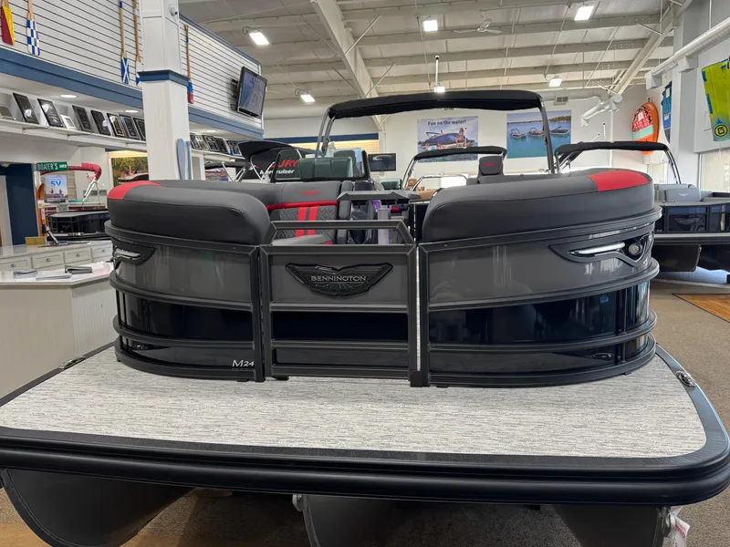 Slide: The Image of 2025 Bennington M Quad Bench 24 MFB pontoon boat displayed in showroom. - 21