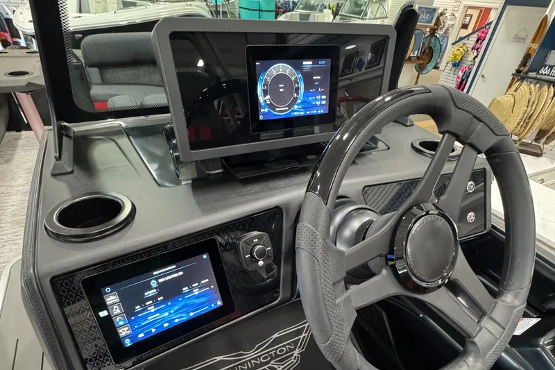Slide: The Image of 2025 Bennington M Quad Bench 24 MFB dashboard with modern digital displays and steering wheel. - 31