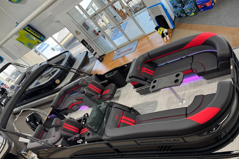 Slide: The Image of 2025 Bennington M Quad Bench 24 MFB pontoon boat with stylish seating and ambient lighting. - 34