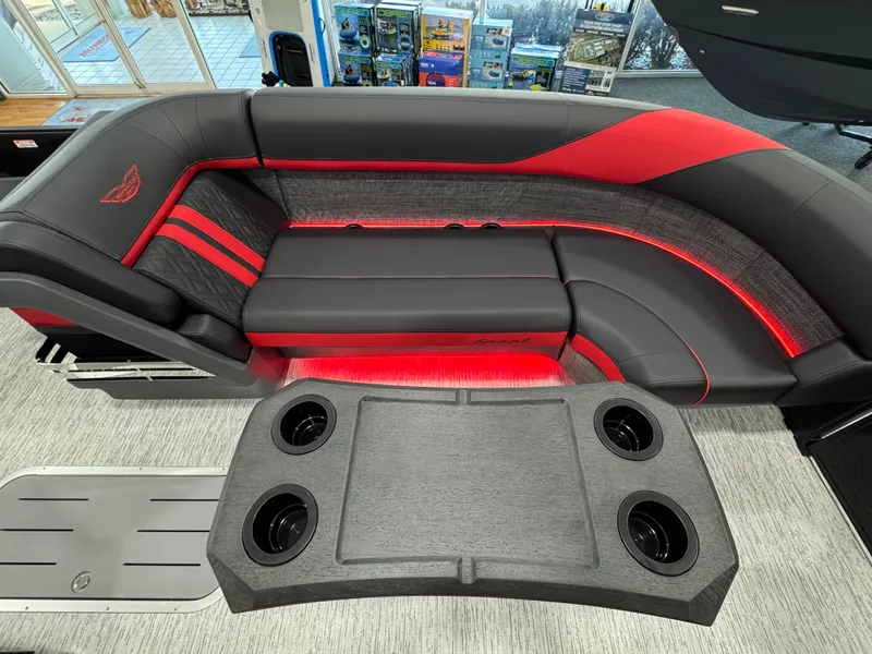 Slide: The Image of 2025 Bennington M Quad Bench 24 MFB with sleek red and black seating and cup holders. - 5