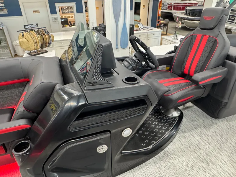 Slide: The Image of 2025 Bennington M Quad Bench 24 MFB boat interior with sleek black and red seating. - 8
