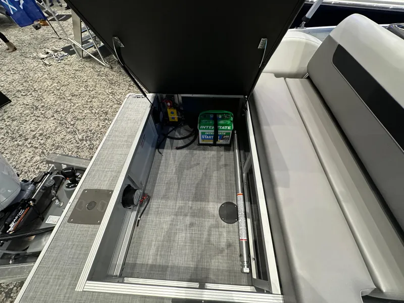 Slide: The Image of 2025 Princecraft Vectra 21 RL boat storage compartment with battery and seating area. - 10