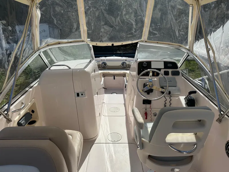 Slide: The Image of 2014 Grady-White 225 Freedom boat interior with steering wheel and seating. - 3