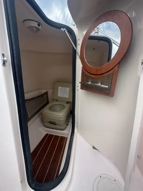 Slide: The Image of 2014 Grady-White 225 Freedom boat interior with toilet and mirror. - 7