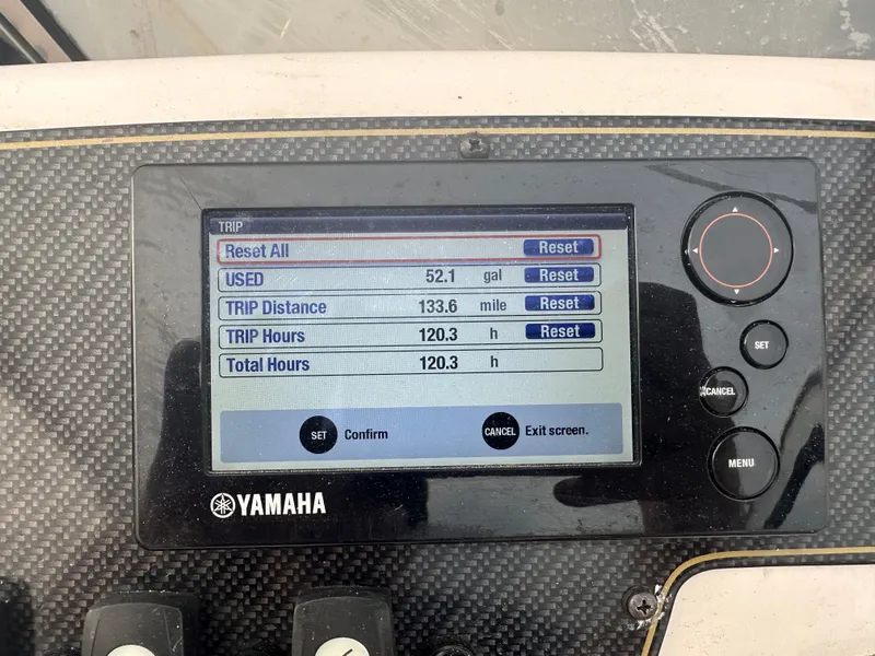 Slide: The Image of Yamaha display showing trip data: 52.1 gallons used, 133.8 miles, 120.3 hours. Grady-White 225 Freedom. - 8