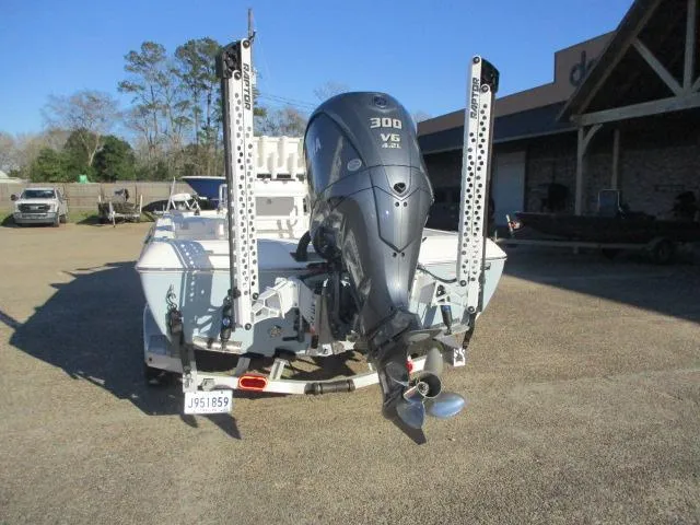 Slide: The Image of 2022 Skeeter SX240 boat with 300 V6 engine, parked outdoors. - 2