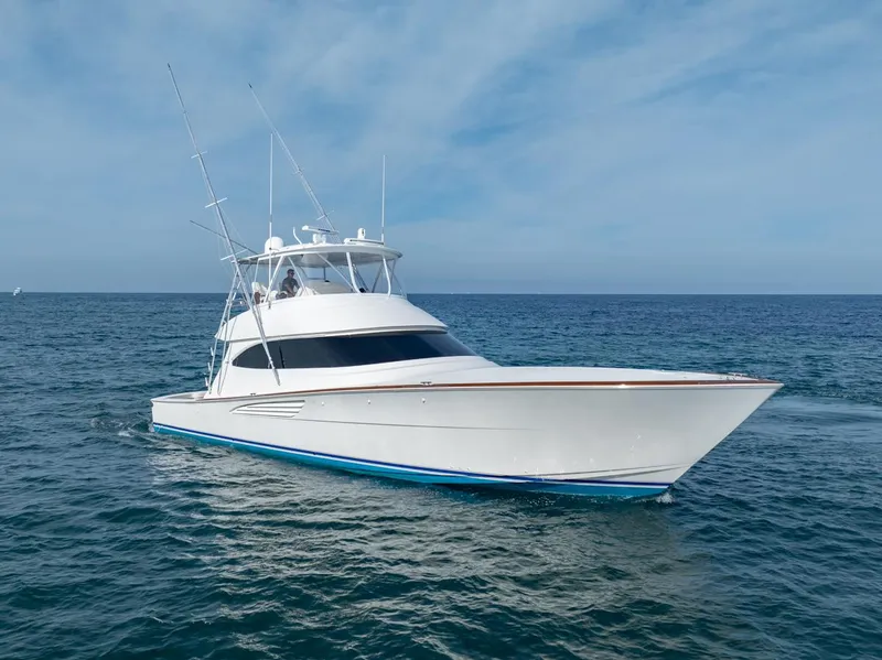 The Image of 2025 Viking 64 Convertible yacht cruising on open sea under clear skies. - 0