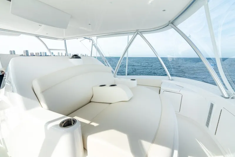 Slide: The Image of Luxurious seating area on 2025 Viking 64 Convertible yacht, overlooking the ocean. - 10