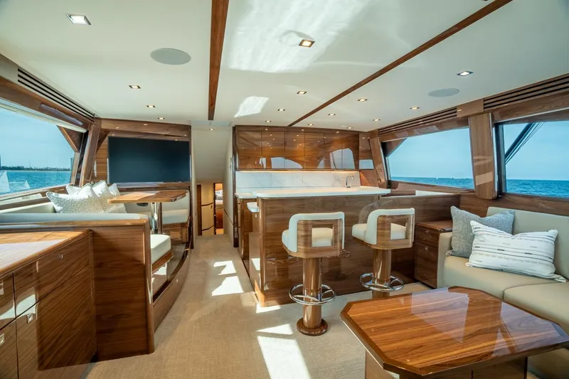 Slide: The Image of Luxurious interior of 2025 Viking 64 Convertible yacht with elegant wood finishes and modern seating. - 12
