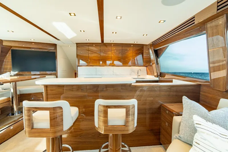 Slide: The Image of Luxurious interior of 2025 Viking 64 Convertible yacht with modern wood finishes and ocean view. - 15