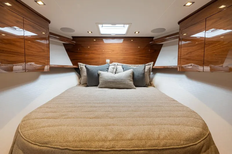 Slide: The Image of Luxurious cabin interior of 2025 Viking 64 Convertible yacht with elegant wood finishes. - 17