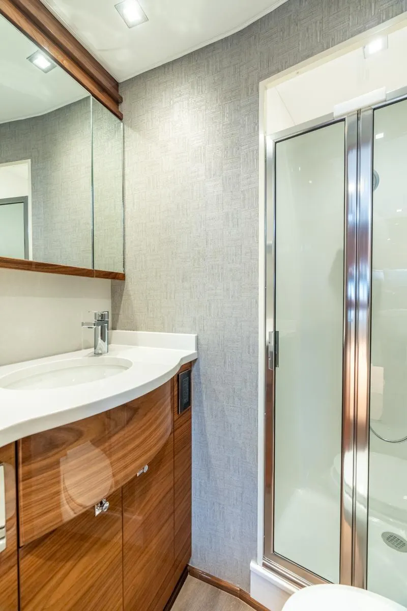 Slide: The Image of Luxurious bathroom in 2025 Viking 64 Convertible yacht with modern fixtures and sleek design. - 22