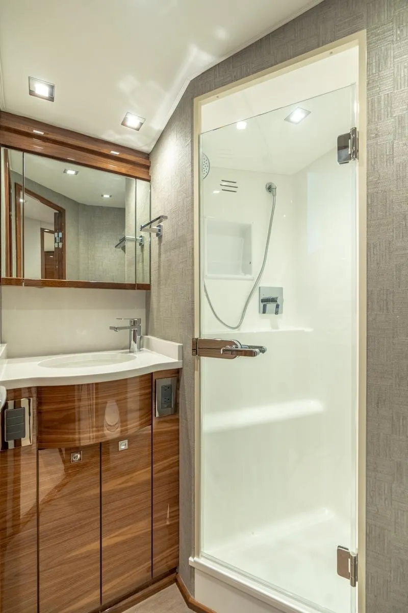Slide: The Image of Luxurious bathroom in 2025 Viking 64 Convertible yacht with modern fixtures and elegant design. - 23