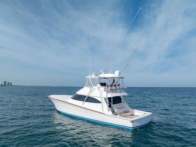 Slide: The Image of 2025 Viking 64 Convertible yacht on open sea under clear sky. - 29