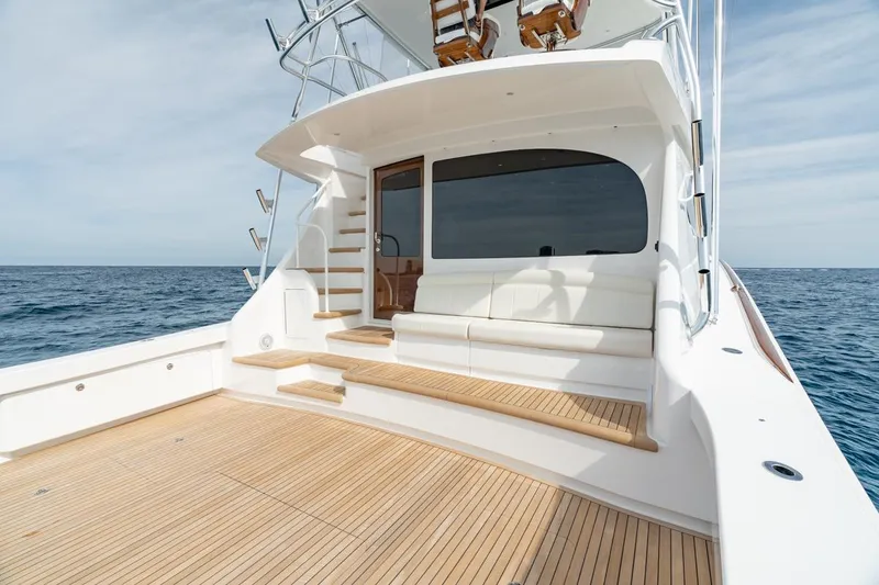 Slide: The Image of 2025 Viking 64 Convertible yacht with spacious deck and luxurious seating. - 3