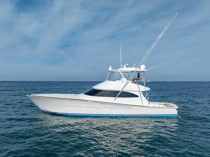 Slide: The Image of 2025 Viking 64 Convertible yacht on open sea under clear sky. - 30