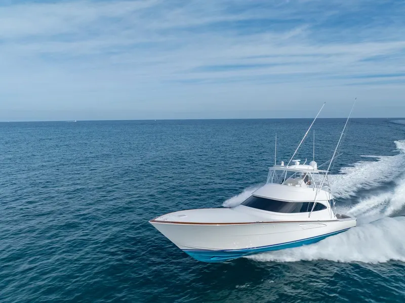 Slide: The Image of 2025 Viking 64 Convertible yacht cruising on open ocean under clear skies. - 34
