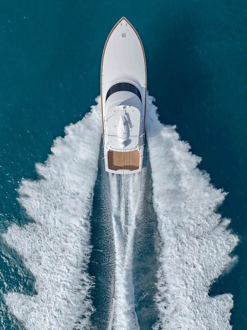 Slide: The Image of Aerial view of 2025 Viking 64 Convertible yacht cruising on blue ocean waters. - 35