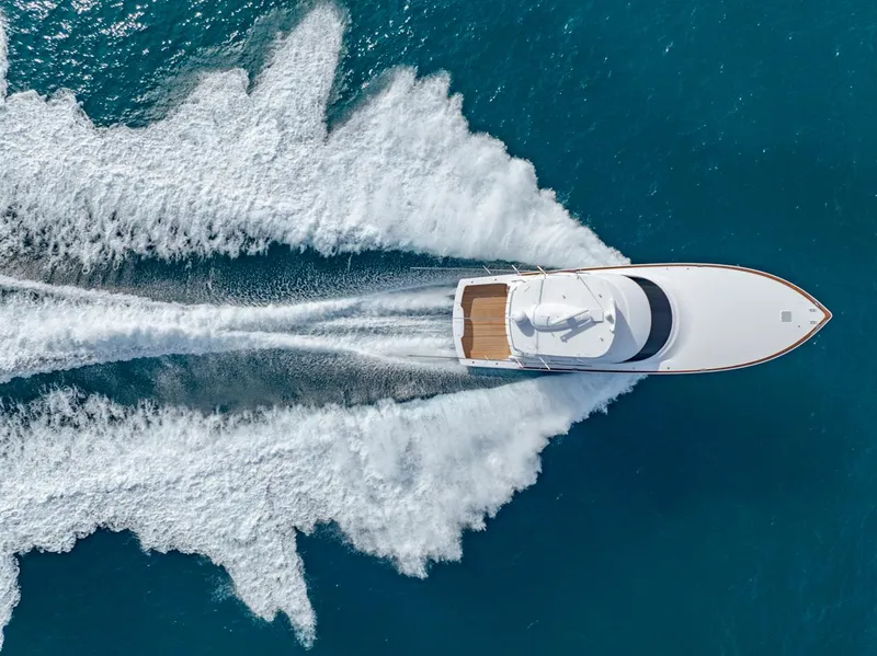 Slide: The Image of Aerial view of 2025 Viking 64 Convertible yacht cruising on blue ocean waters. - 36
