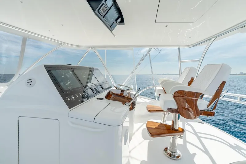 Slide: The Image of 2025 Viking 64 Convertible yacht helm with luxurious seating and ocean view. - 6