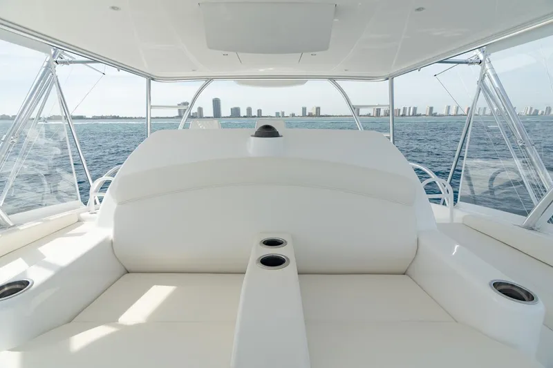 Slide: The Image of 2025 Viking 64 Convertible yacht interior with ocean view and city skyline in background. - 9