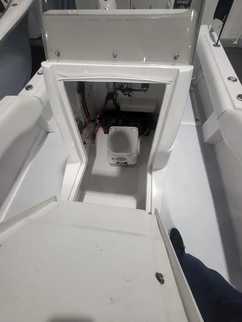 Slide: The Image of 2025 ArrowCat 20CC boat interior with open storage compartment and visible equipment. - 12