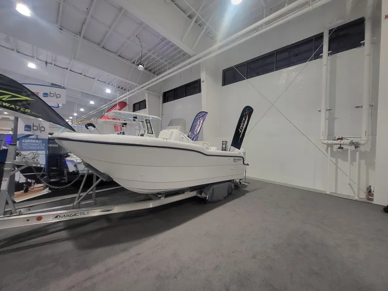 The Image of 2025 ArrowCat 20CC boat displayed indoors on a trailer at a boat show. - 6