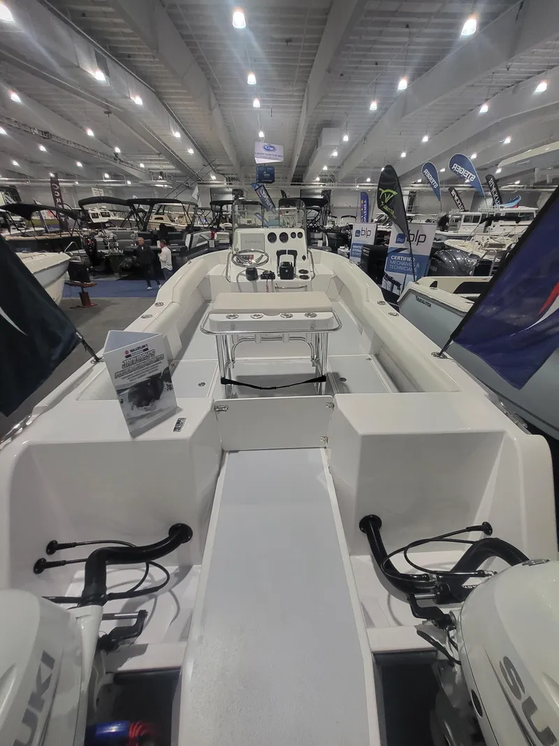 Slide: The Image of 2025 ArrowCat 20CC boat interior at a boat show, featuring modern controls and seating. - 7