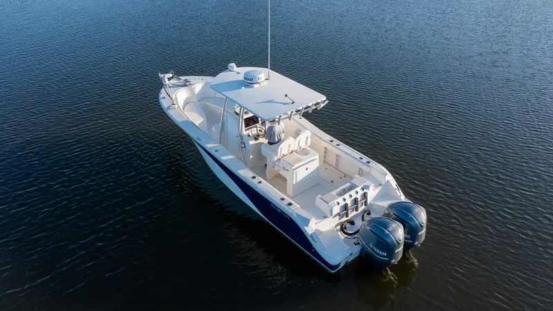 Slide: The Image of 2012 Sea Fox 286 Commander boat on calm water, featuring dual outboard motors. - 12