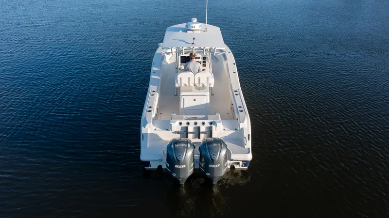 Slide: The Image of 2012 Sea Fox 286 Commander boat on calm water, rear view with dual engines. - 13