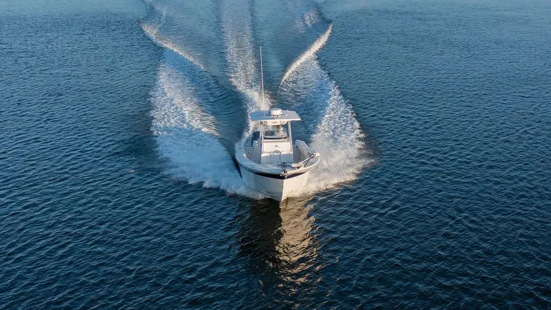 Slide: The Image of Sea Fox 286 Commander 2012 cruising on open water, creating a dynamic wake. - 23
