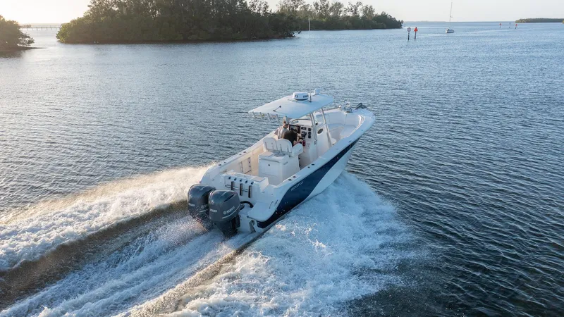 Slide: The Image of 2012 Sea Fox 286 Commander boat cruising on open water, creating a wake. - 26