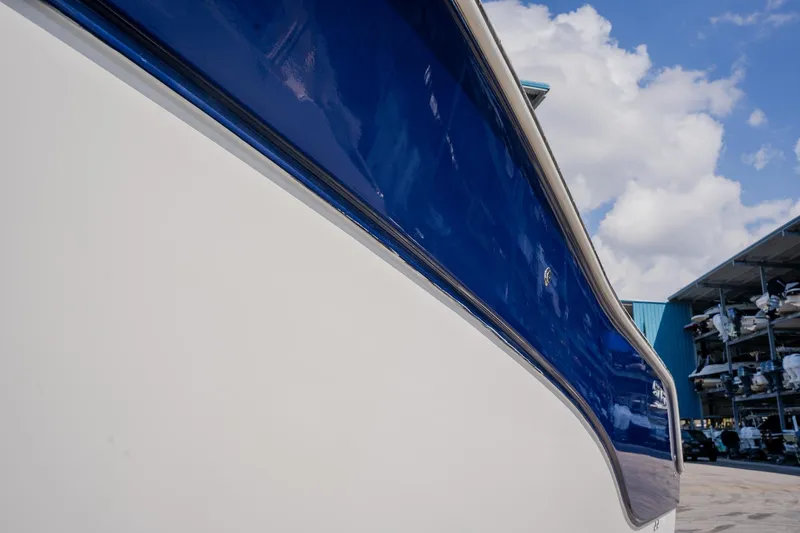 Slide: The Image of 2012 Sea Fox 286 Commander boat with blue and white hull under a cloudy sky. - 34