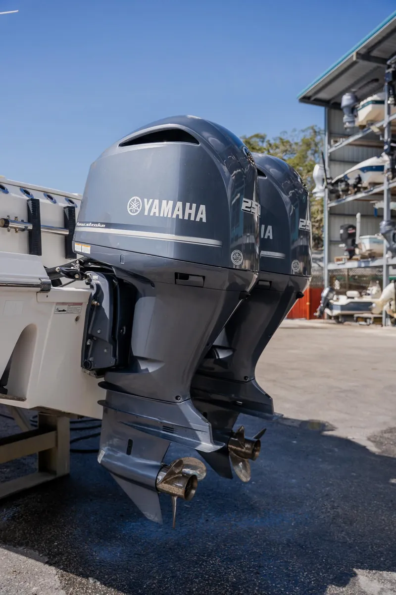Slide: The Image of Twin Yamaha outboard motors on a 2012 Sea Fox 286 Commander boat, parked outdoors. - 37