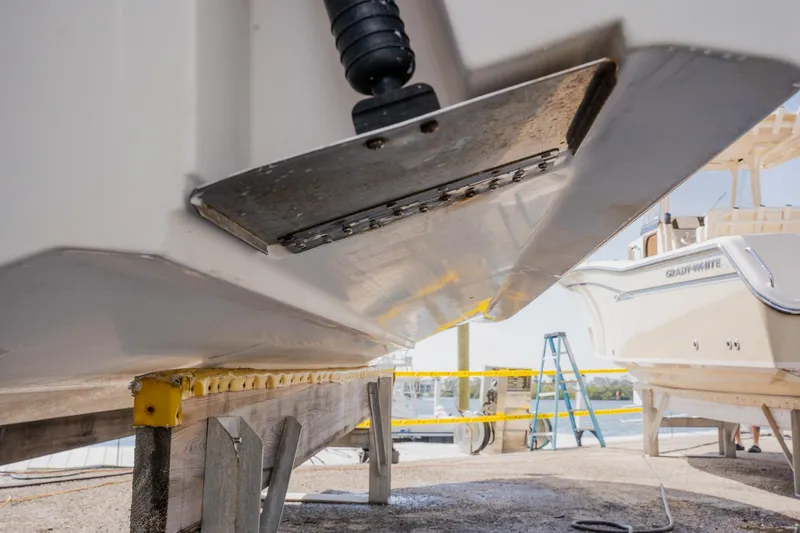 Slide: The Image of Close-up of a 2012 Sea Fox 286 Commander boat hull on a stand, with a ladder nearby. - 39