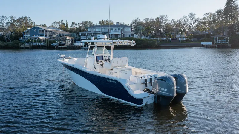 Slide: The Image of 2012 Sea Fox 286 Commander boat on calm water, featuring dual Yamaha engines. - 4