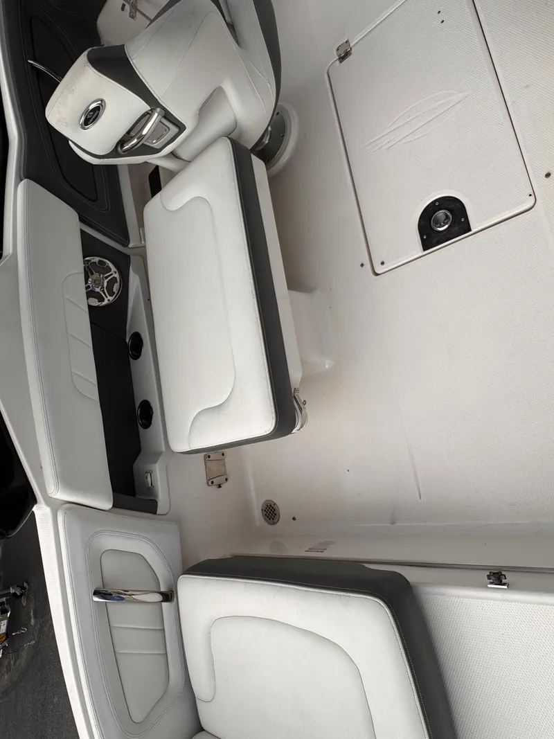 Slide: The Image of 2013 Chaparral 257 SSX boat interior with white seating and modern dashboard. - 10