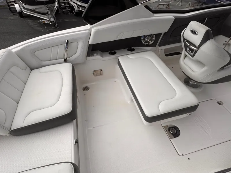 Slide: The Image of Interior of 2013 Chaparral 257 SSX boat with white seating and storage compartments. - 11