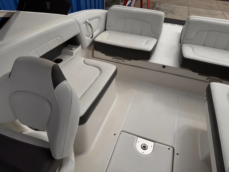 Slide: The Image of 2013 Chaparral 257 SSX boat interior with white seating and sleek design. - 17