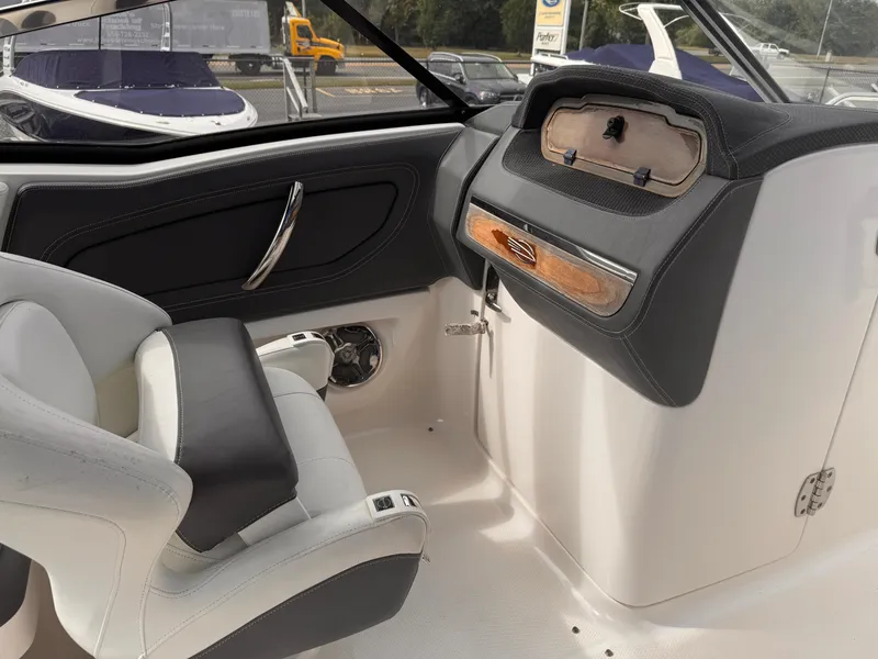 Slide: The Image of 2013 Chaparral 257 SSX boat dashboard with steering wheel and control panel. - 24